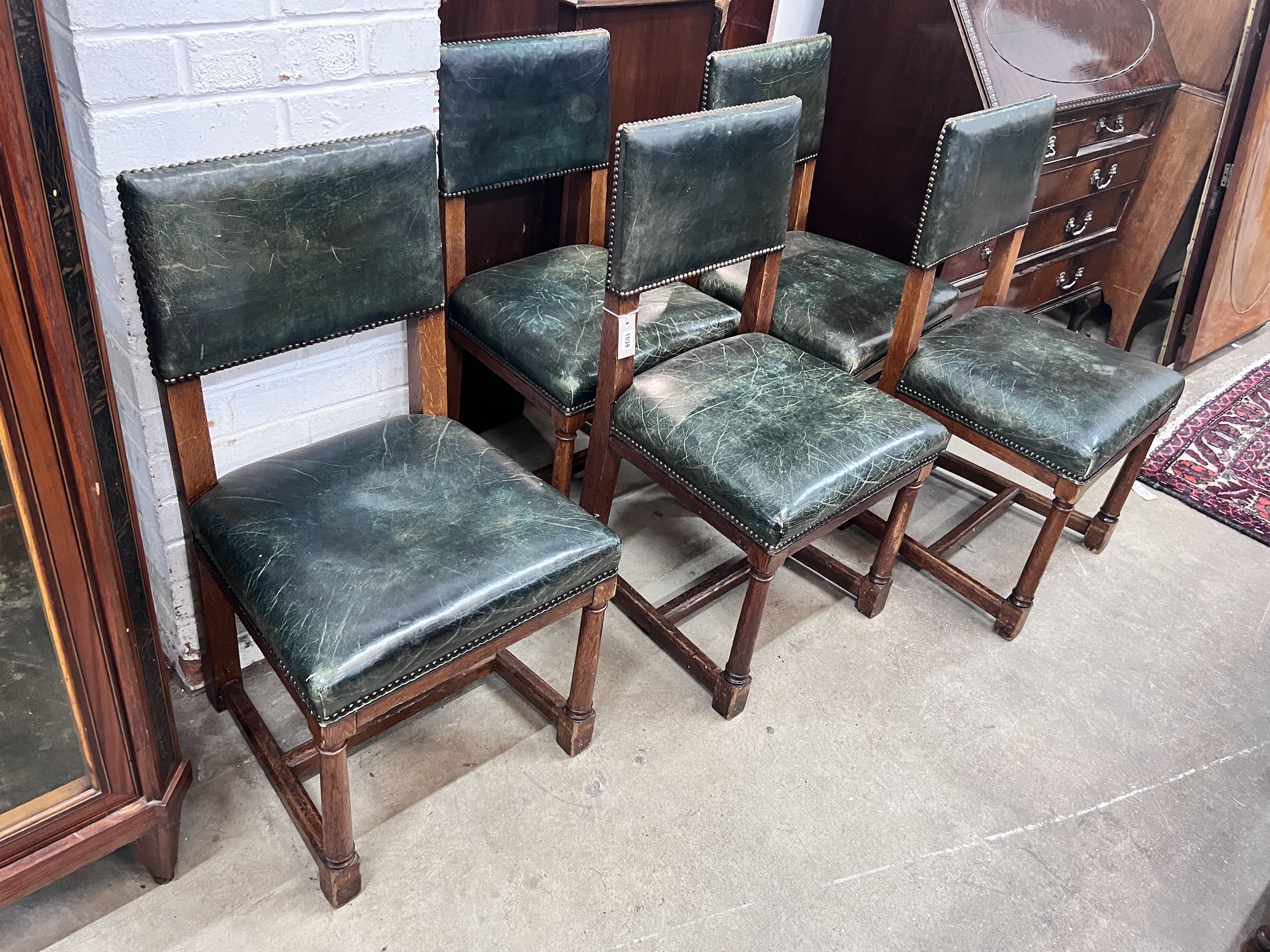 A set of five George VI oak and green leather 'House of Parliament' chairs by R & H Mines, Downley, width 46cm, depth 43cm, height 86cm